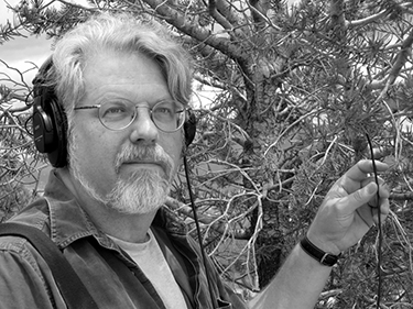 UC Santa Cruz music professor David Dunn listening to bark beetles